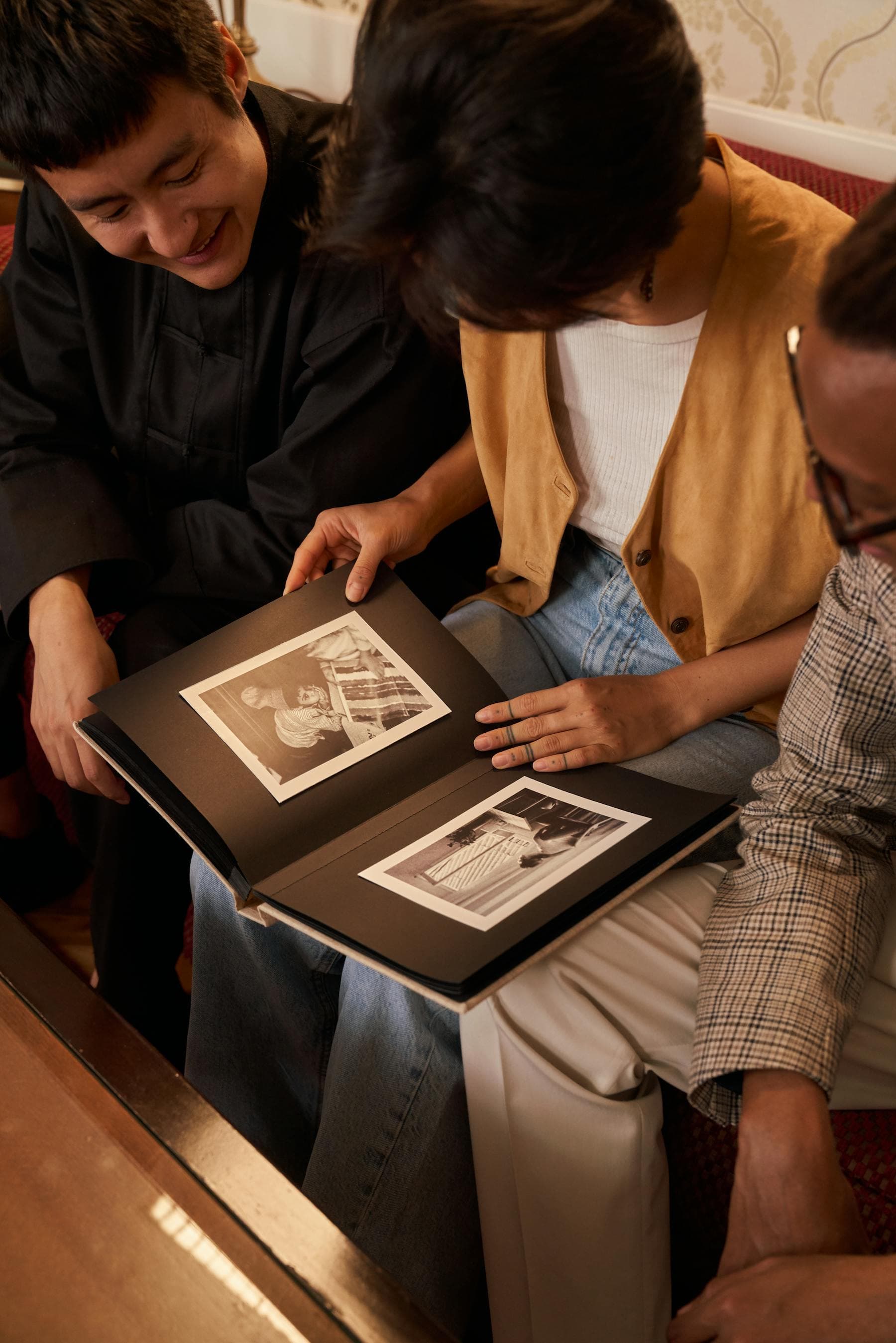 Family members reviewing old photos before verifying a family tree branch